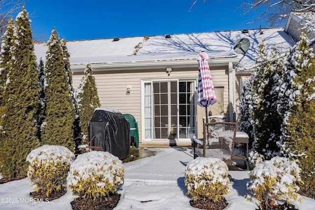 snow covered patio with area for grilling