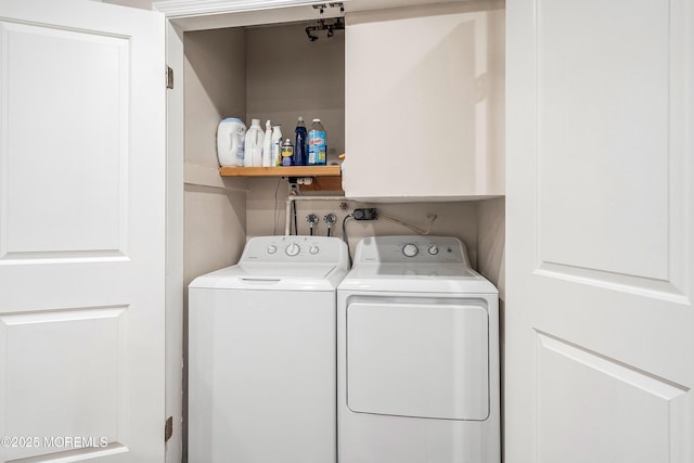 clothes washing area with washing machine and clothes dryer