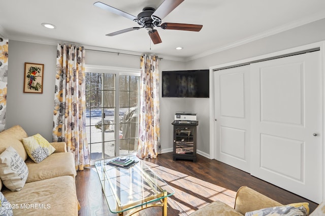 living room featuring crown molding, ceiling fan, and dark wood-type flooring