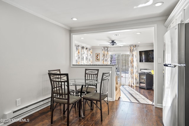 dining area featuring a baseboard radiator, ornamental molding, dark hardwood / wood-style floors, and ceiling fan