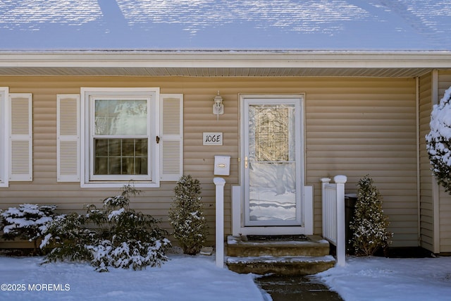 view of snow covered property entrance