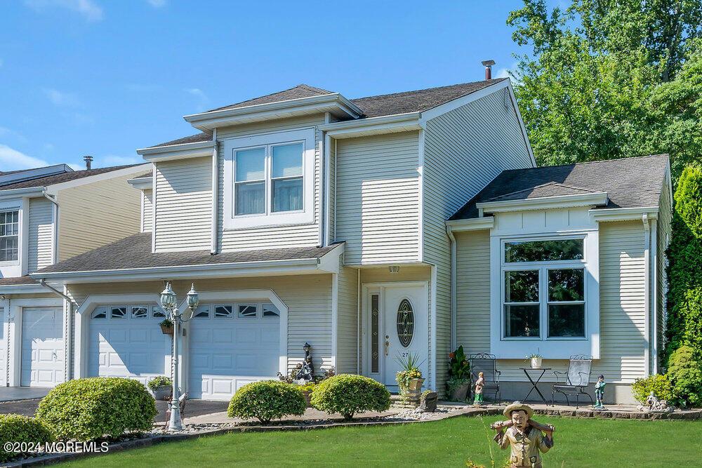 view of front of property featuring a garage and a front lawn