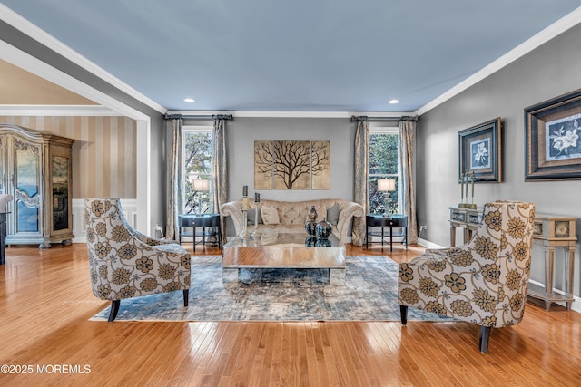 living room featuring crown molding, hardwood / wood-style floors, and plenty of natural light