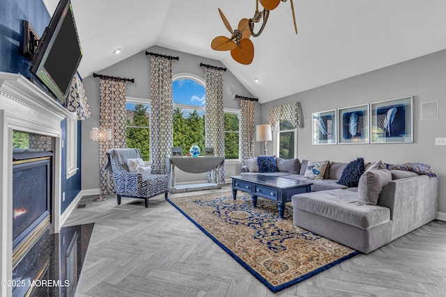 living room featuring ceiling fan, parquet floors, and vaulted ceiling