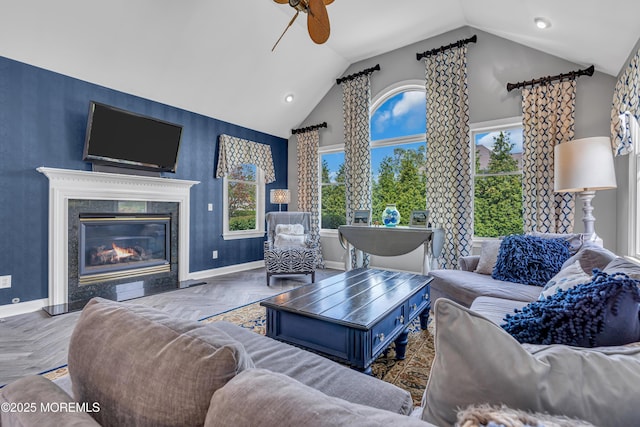 living room featuring a healthy amount of sunlight, parquet floors, and a premium fireplace