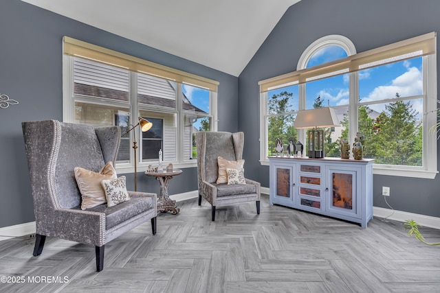 sitting room with lofted ceiling and parquet flooring