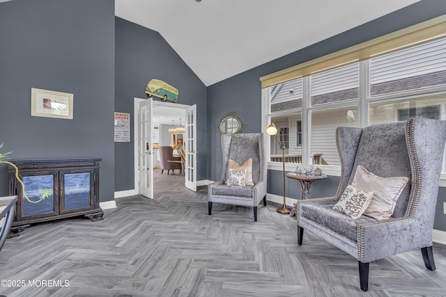 sitting room featuring french doors, high vaulted ceiling, and parquet flooring