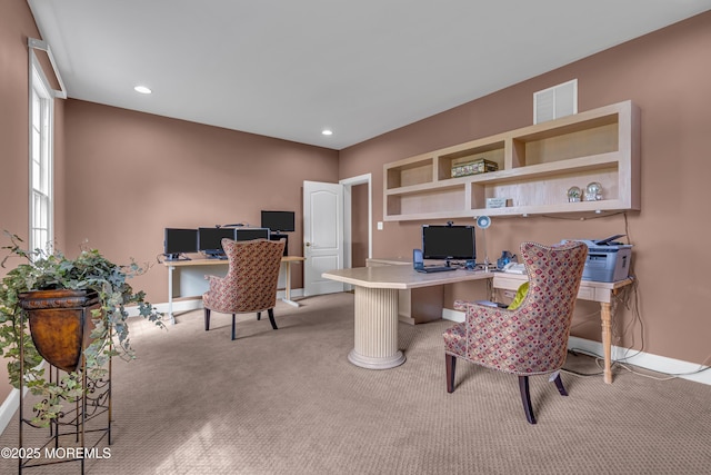 office space with light carpet and built in desk