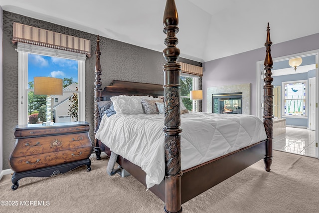 carpeted bedroom featuring lofted ceiling