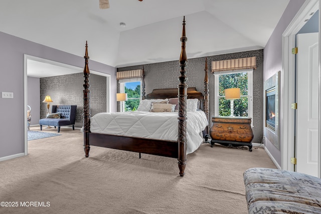 bedroom with vaulted ceiling, ceiling fan, and light colored carpet