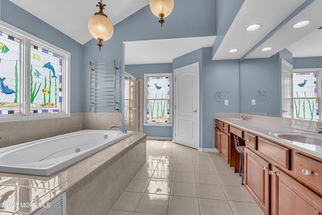 bathroom with tiled bath, a wealth of natural light, vanity, and lofted ceiling