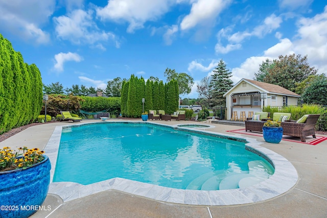 view of pool featuring an in ground hot tub, a patio, a bar, an outdoor structure, and an outdoor hangout area