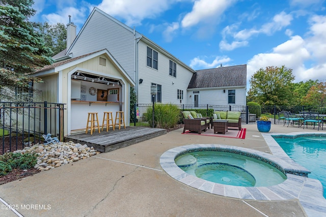 back of property with a pool with hot tub, a patio, an outdoor bar, and outdoor lounge area