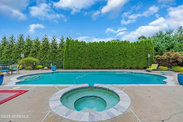 view of swimming pool with an in ground hot tub and a patio area