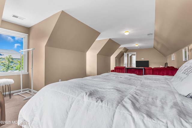 carpeted bedroom featuring lofted ceiling