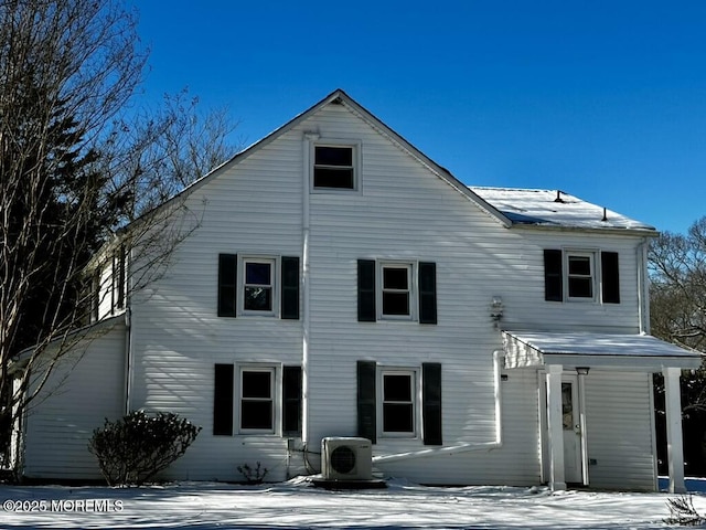 snow covered property featuring ac unit