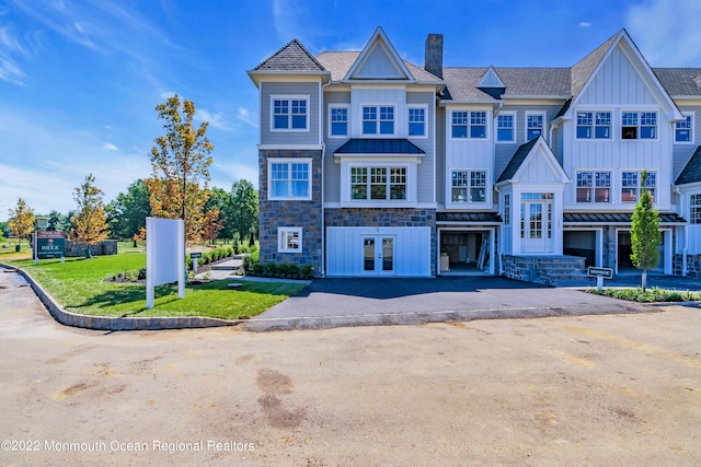 view of property featuring a front yard and french doors