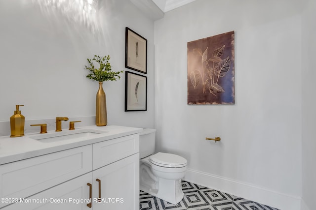 bathroom featuring crown molding, tile patterned floors, vanity, and toilet