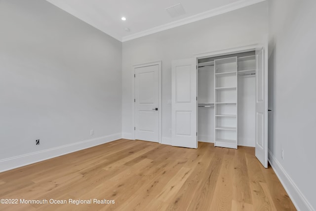 unfurnished bedroom featuring wood-type flooring and ornamental molding