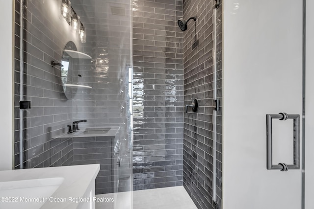 bathroom with vanity and a shower with door