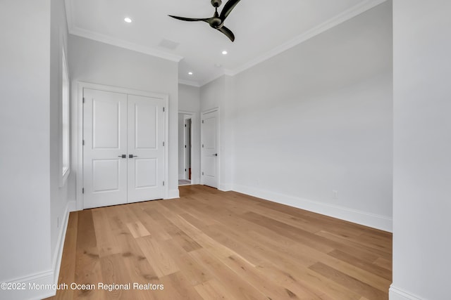 unfurnished bedroom with crown molding, a closet, ceiling fan, and light wood-type flooring