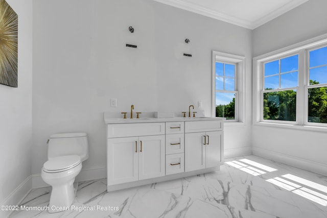 bathroom with vanity, crown molding, and toilet