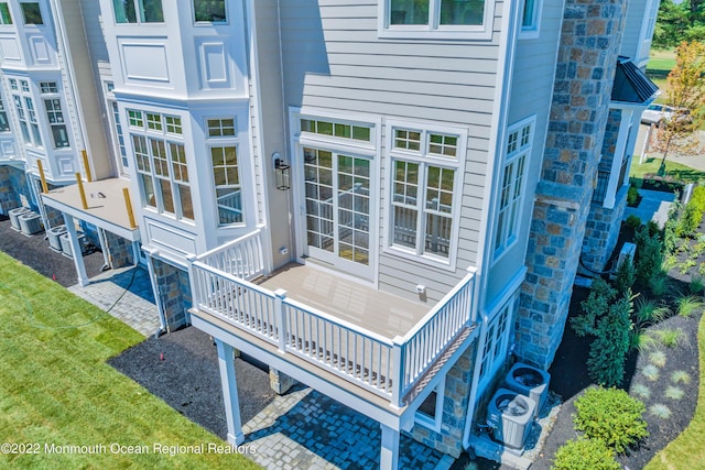 rear view of house featuring central AC unit