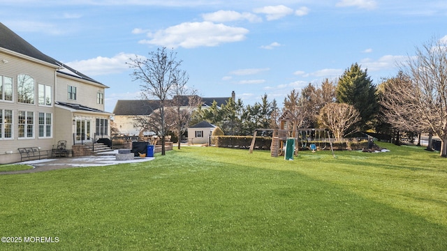 view of yard featuring a playground and a patio