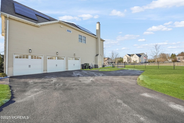 view of property exterior with a garage and a yard