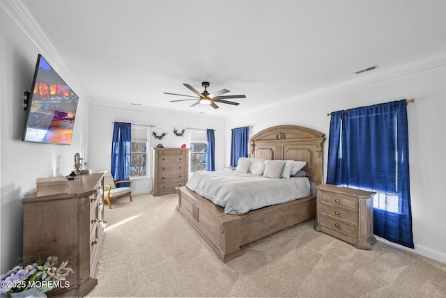 bedroom with crown molding, ceiling fan, light colored carpet, and multiple windows