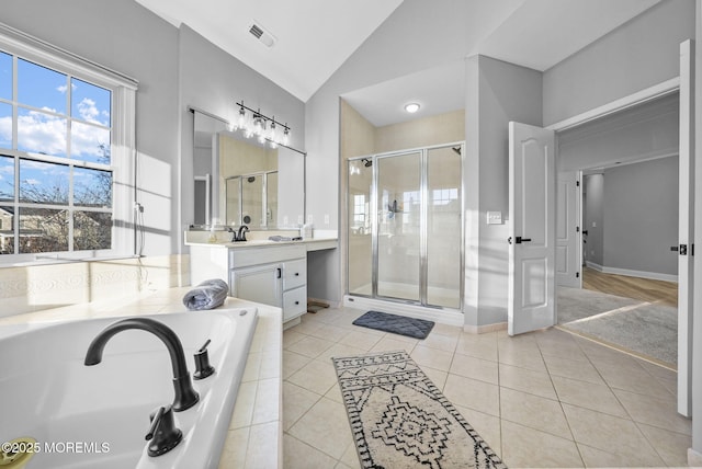 bathroom with tile patterned floors, vanity, independent shower and bath, and vaulted ceiling