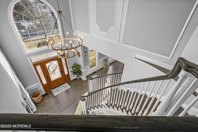 entrance foyer featuring dark hardwood / wood-style flooring, a notable chandelier, and a high ceiling