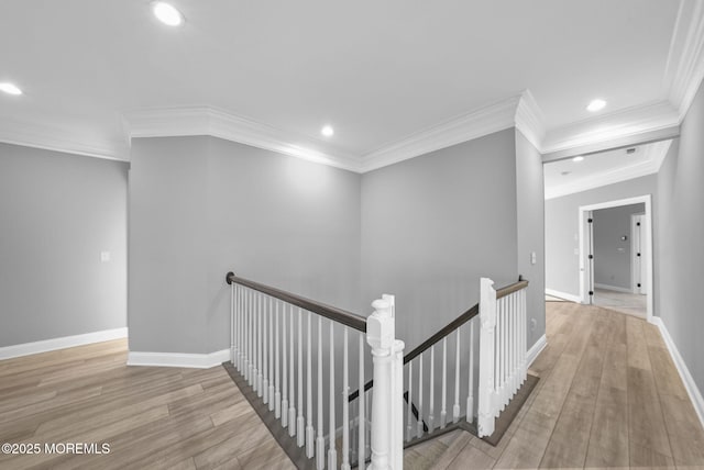 hall with crown molding and light hardwood / wood-style floors