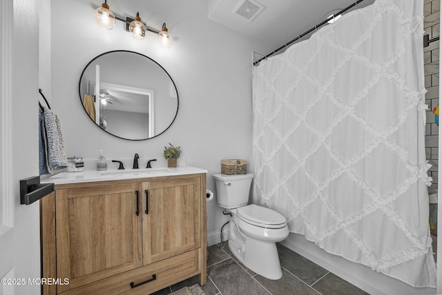 full bathroom featuring shower / tub combo with curtain, tile patterned floors, toilet, and vanity