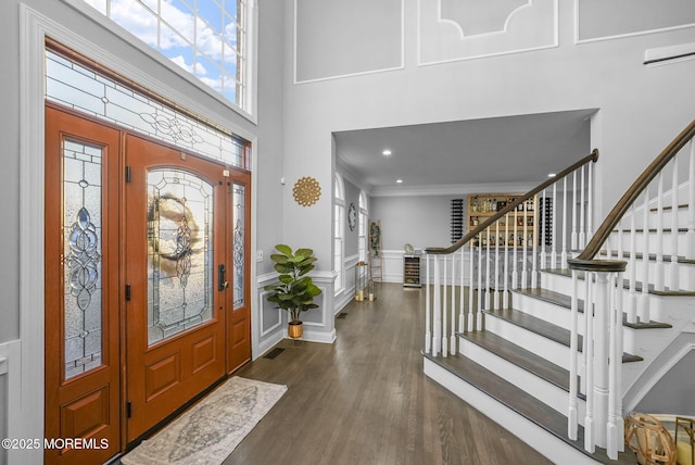 foyer with dark hardwood / wood-style flooring and crown molding