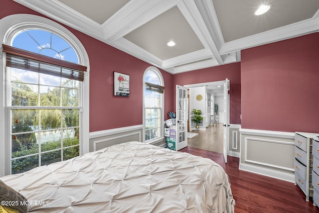 bedroom featuring dark hardwood / wood-style floors, coffered ceiling, ornamental molding, french doors, and beamed ceiling