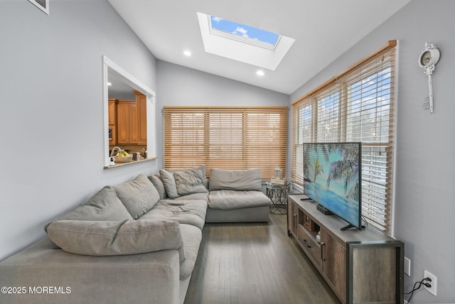 living room featuring dark hardwood / wood-style flooring and vaulted ceiling with skylight