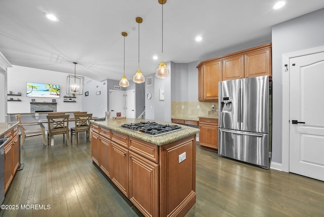 kitchen featuring tasteful backsplash, dark hardwood / wood-style floors, a kitchen island, pendant lighting, and stainless steel appliances