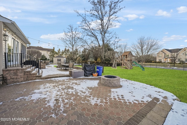 view of patio / terrace with an outdoor fire pit and a playground