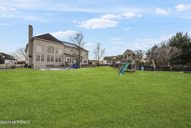 view of yard with a patio and a playground