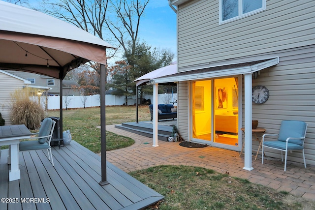 wooden deck with a patio area and a lawn