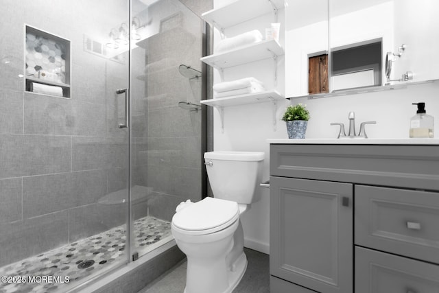 bathroom with vanity, an enclosed shower, and toilet