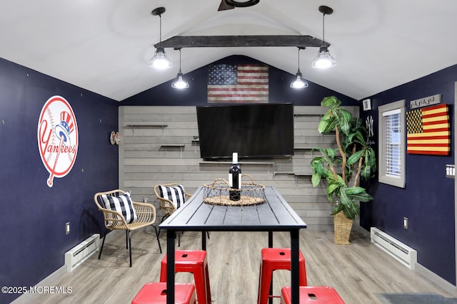 dining room with vaulted ceiling with beams, light hardwood / wood-style floors, and baseboard heating