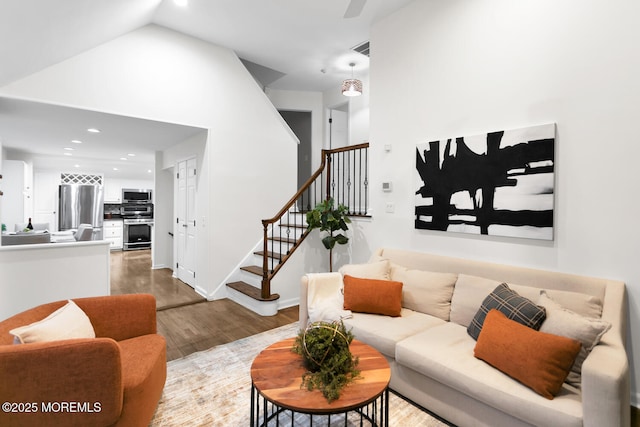 living room with vaulted ceiling and hardwood / wood-style floors