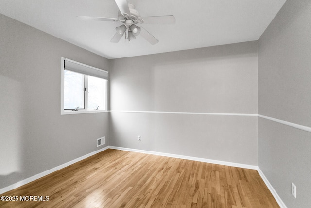 empty room with ceiling fan and light wood-type flooring