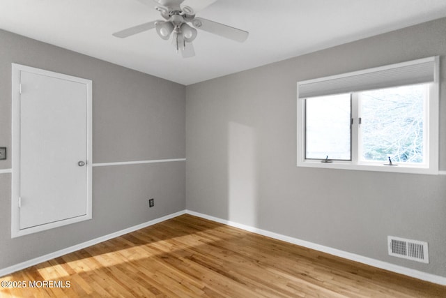 unfurnished room with hardwood / wood-style floors and ceiling fan