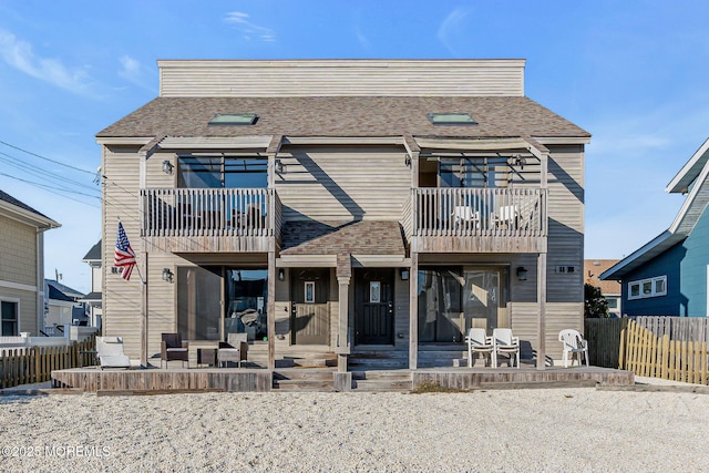 view of property featuring a balcony and a patio area