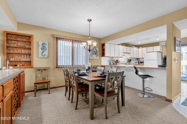 carpeted dining space with a textured ceiling and a notable chandelier