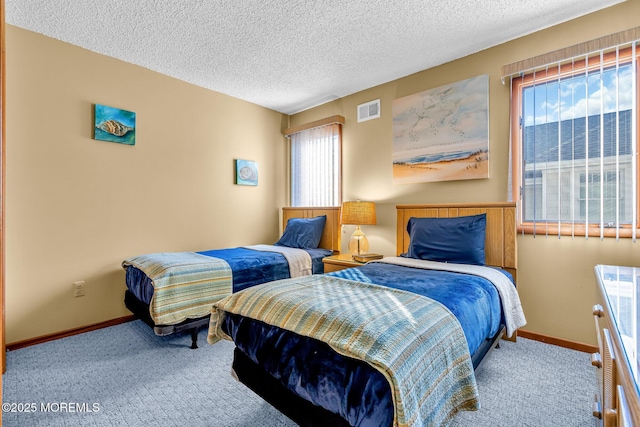 carpeted bedroom featuring a textured ceiling