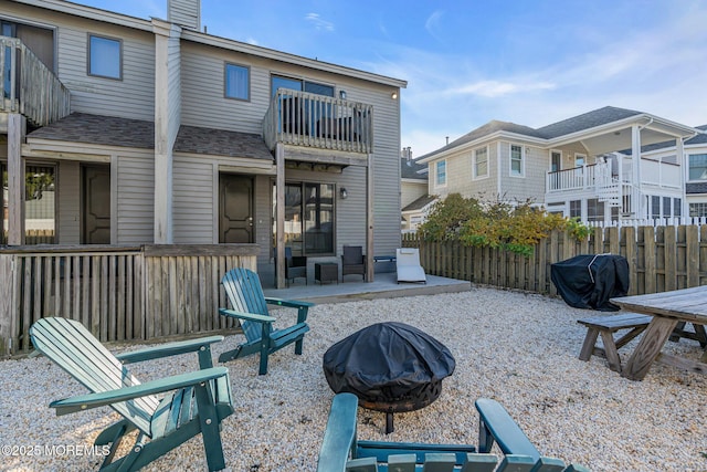 back of house featuring a patio area, an outdoor fire pit, and a balcony